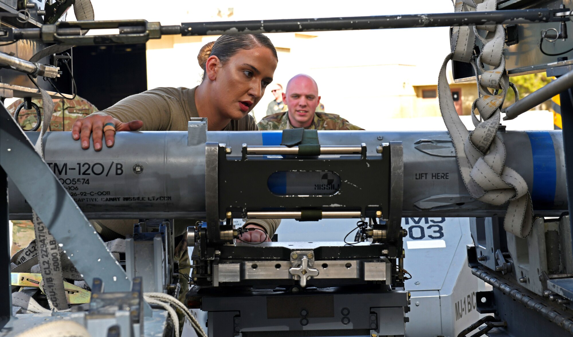 Staff Sgt. Katrina Stuhl, 310th Aircraft Maintenance Unit weapons load crew chief, prepares an inert munition to be loaded onto an F-16 Fighting Falcon during the Annual Load Crew Competition Jan. 24, 2020, at Luke Air Force Base, Ariz.