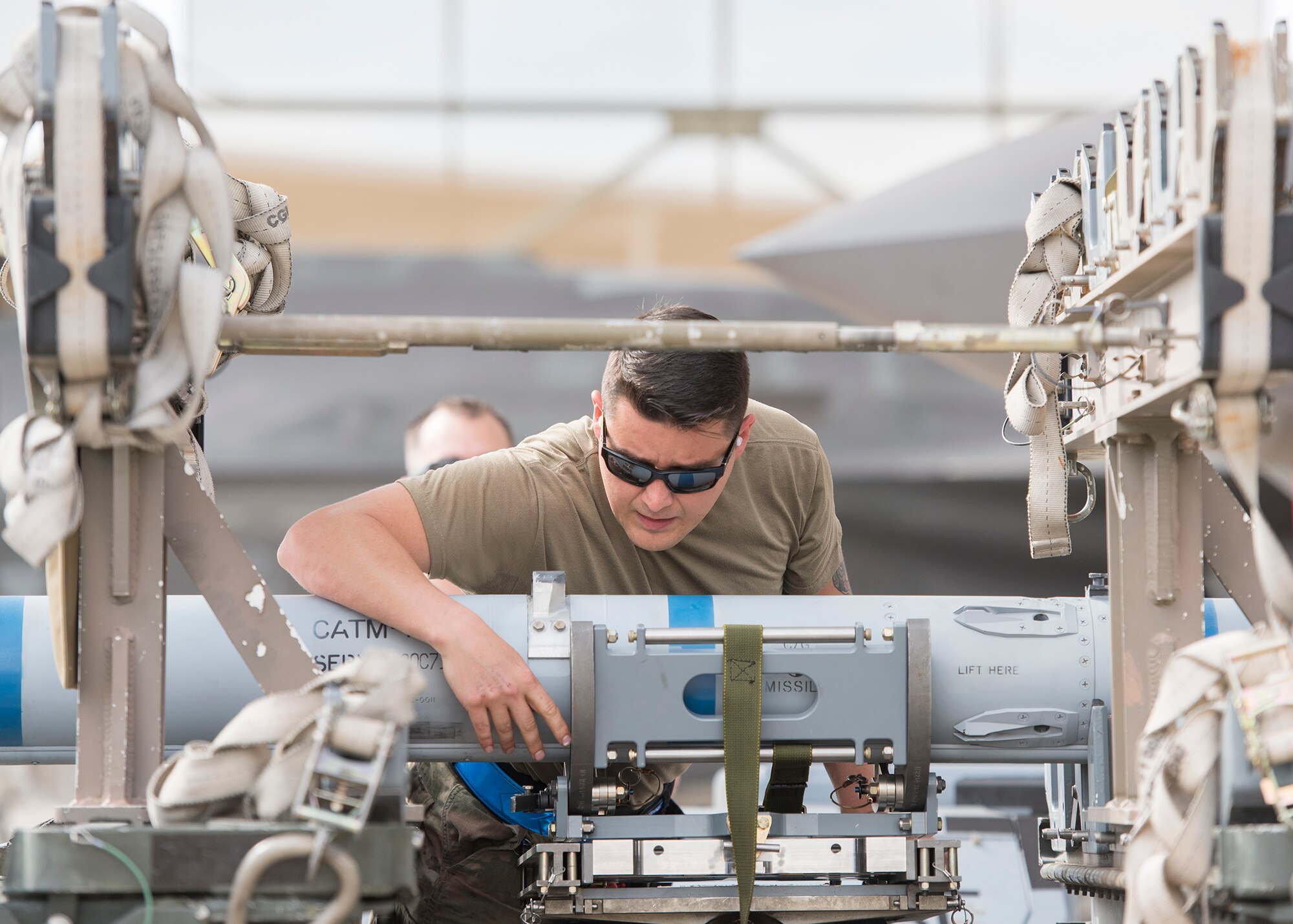 Staff Sgt. Joseph Cius, 944th Aircraft Maintenance Unit weapons load crew chief, inspects an inert munition before loading it on an F-35A Lightning II during the Annual Load Crew Competition, Jan. 24, 2020, at Luke Air Force Base, Ariz.