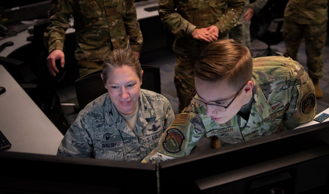 From left, Col. Laurel Walsh, 50th Operations Group commander, and Airman 1st Class Michael McCowan, 2nd Space Operations Squadron satellite systems operator and mission planner, give the final command to decommission Satellite Vehicle Number-36 at Schriever Air Force Base, Colorado, Jan. 27, 2020. SVN-36 was launched March 10, 1994, and exceeded its design life of approximately seven years. (U.S. Air Force photo by Airman Amanda Lovelace)