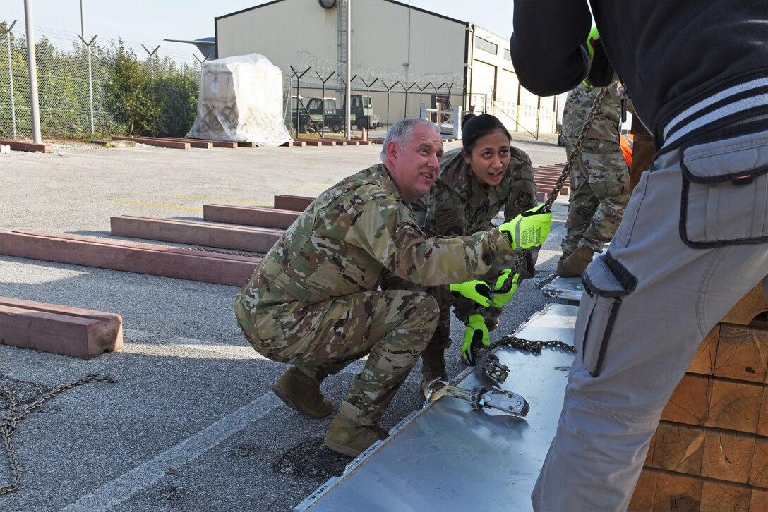 U.S. Air Force Maj. Gen. John Gordy, U.S. Air Force Expeditionary Center commander, assists his team during a pallet building competition with Airmen from the 724th Air Mobility Squadron and the 31st Logistics Readiness Squadron at Aviano Air Base, Italy, Jan. 24, 2020. The competition was part of a site visit conducted by the USAF Expeditionary Center as part of a larger visit to the geographically separated units under the 521st Air Mobility Operations Wing’s area of responsibility.