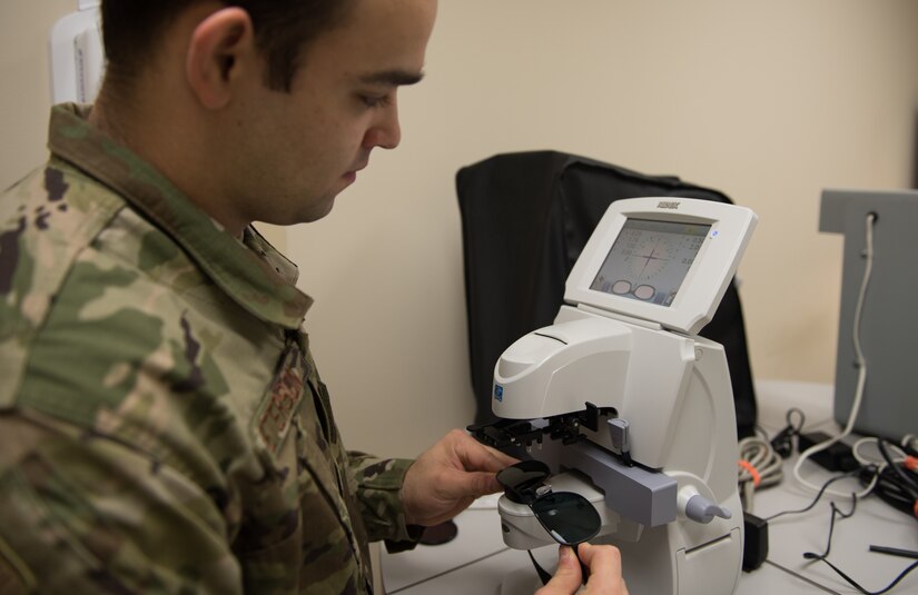 U.S. Air Force Senior Airman Alexander Peterson, 633rd Aerospace Medical Squadron ophthalmic technician, measures a patient’s prescription eyeglasses using a lensometer at Joint Base Langley-Eustis, Virginia, Jan. 27, 2020. The lensometer tells where the light is coming in. (U.S. Air Force photo by Airman 1st Class Sarah Dowe)