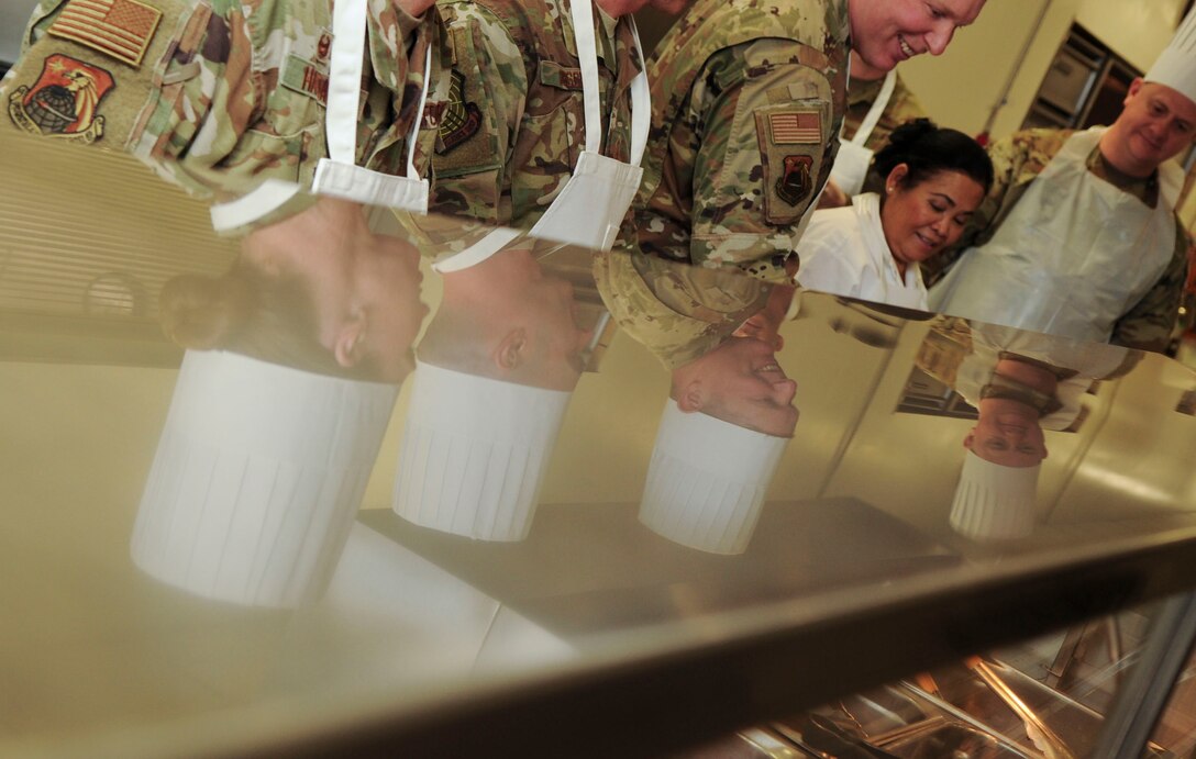 Group commanders, superintendents and first sergeants from the National Air and Space Intelligence Center, prepare food at the Pitsenbarger Dining Facility on Wright-Patterson Air Force Base, Ohio on Jan. 24, 2020.  The group was able to use their role as servers for a day as a way to get out amongst Airmen in a more relaxed and open environment. (U.S. Air Force photo Staff Sgt. Seth Ray Stang)