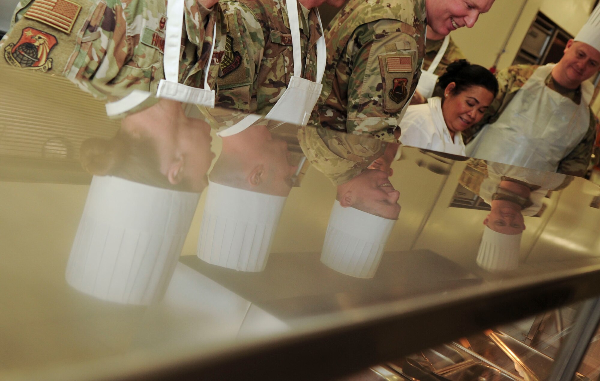 Group commanders, superintendents and first sergeants from the National Air and Space Intelligence Center, prepare food at the Pitsenbarger Dining Facility on Wright-Patterson Air Force Base, Ohio on Jan. 24, 2020.  The group was able to use their role as servers for a day as a way to get out amongst Airmen in a more relaxed and open environment. (U.S. Air Force photo Staff Sgt. Seth Ray Stang)