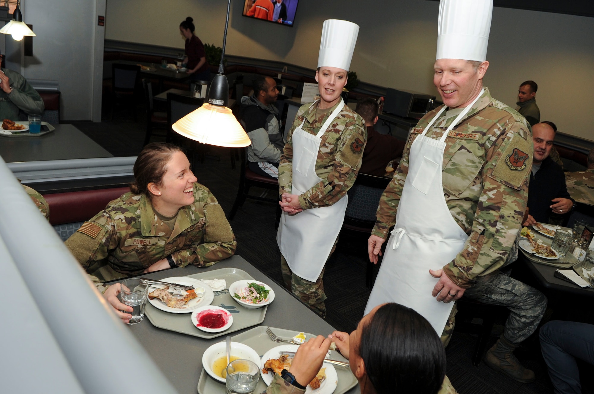 Col. Mary Haddad, Geospatial and Signatures Intelligence Group commander and Chief MSgt. Randy Novobilski, GS superintendent speak with Airmen at the Pitsenbarger Dining Facility on Wright-Patterson Air Force Base, Ohio on Jan. 24, 2020. Haddad and Novobilski were part of a group of commanders, superintendents and first sergeants who prepared and served food at the dining facility as a means to interact with junior enlisted on a more personal level. (U.S. Air Force photo Staff Sgt. Seth Ray Stang)