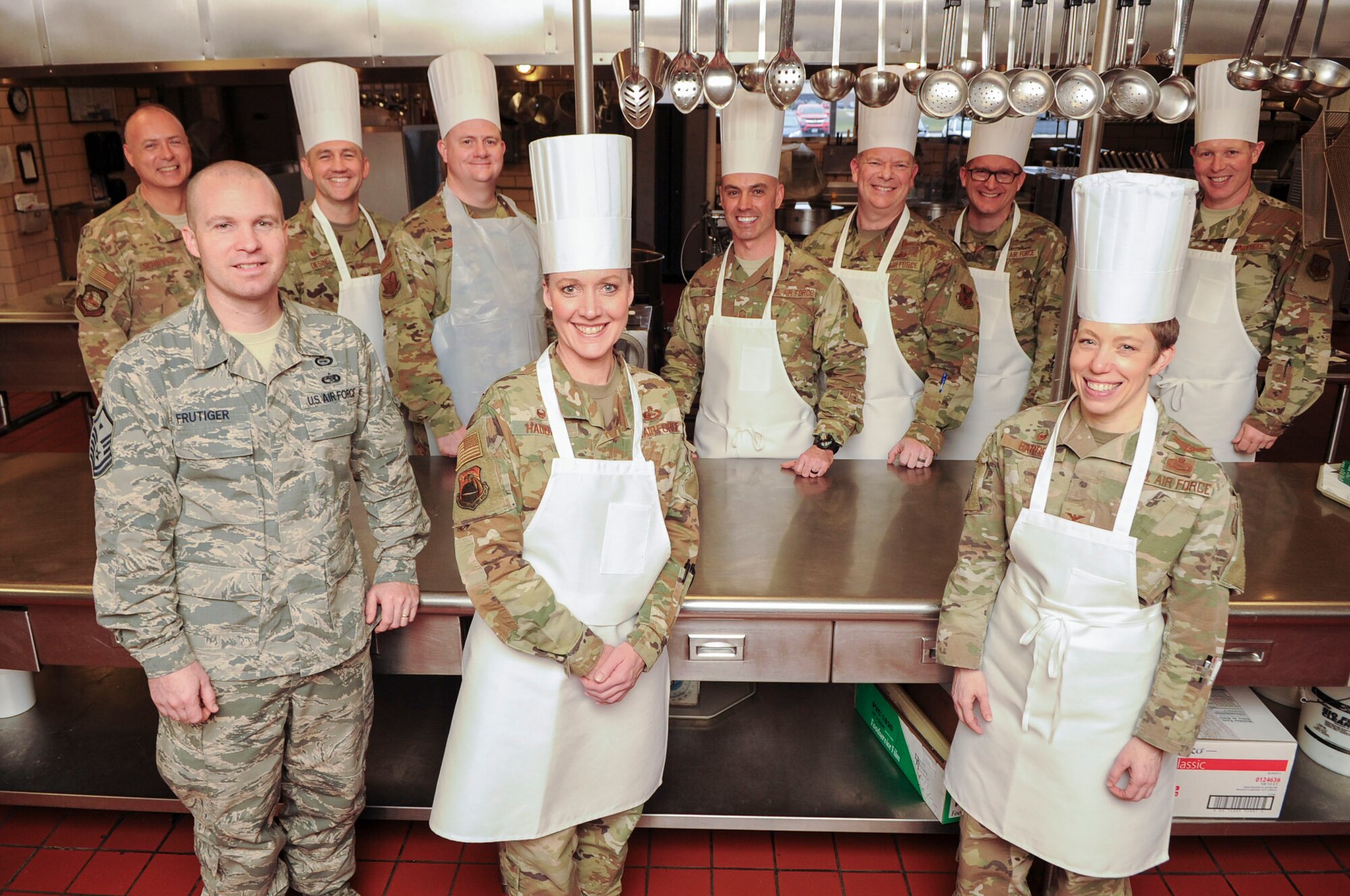 Group commanders, superintendents and first sergeants from the National Air and Space Intelligence Center, pose for a photograph after preparing and serving food at the Pitsenbarger Dining Facility on Wright-Patterson Air Force Base, Ohio on Jan. 24, 2020.  The group intends to take part in similar events in the future as a way to prioritize Airmen and make a positive and visible impact on the base community.   (U.S. Air Force photo Staff Sgt. Seth Ray Stang)