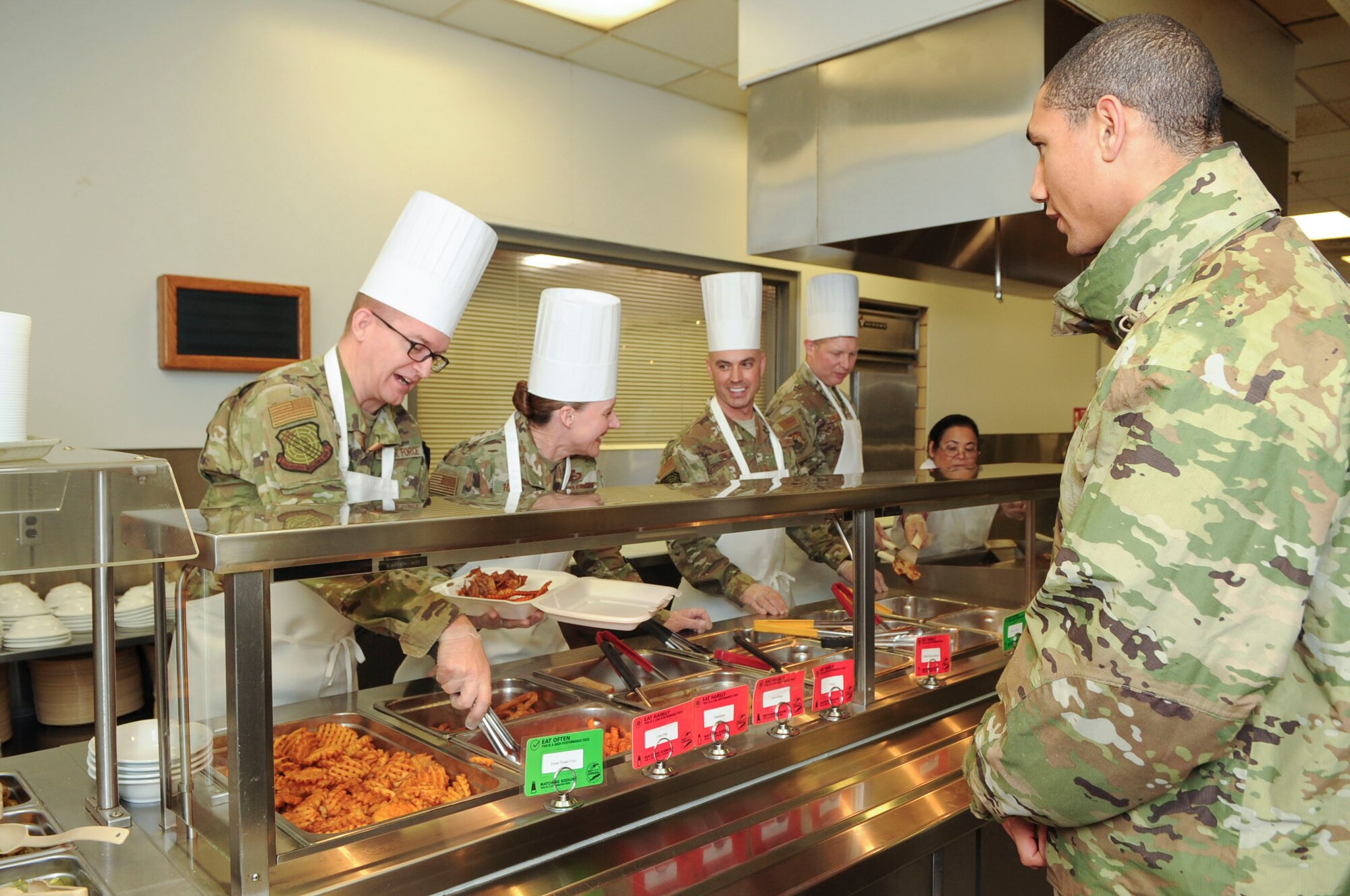 Group commanders, superintendents and first sergeants from the National Air and Space Intelligence Center, prepare food at the Pitsenbarger Dining Facility on Wright-Patterson Air Force Base, Ohio on Jan. 24, 2020.  The group was able to use their role as servers for a day as a way to get out amongst Airmen in a more relaxed and open environment. (U.S. Air Force photo Staff Sgt. Seth Ray Stang)