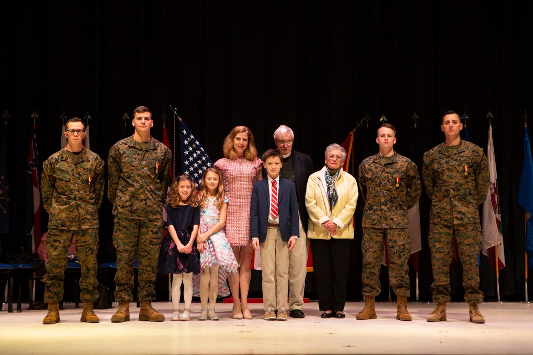 Staff Sgt. Leary Reicharwarfel (left), Sgt. Anders Larson, Cpl. Austin McMullen, and Cpl. Timothy Watson pose for a photo with the family they saved after receiving the Navy and Marine Corps Medal at Marine Corps Air Station Cherry Point, N.C., Jan. 28, 2019. The Marines received this award for his heroic efforts while saving a family at Atlantic Beach, N.C. (U.S. Marine Corps photo by Staff Sgt. William L. Holdaway)