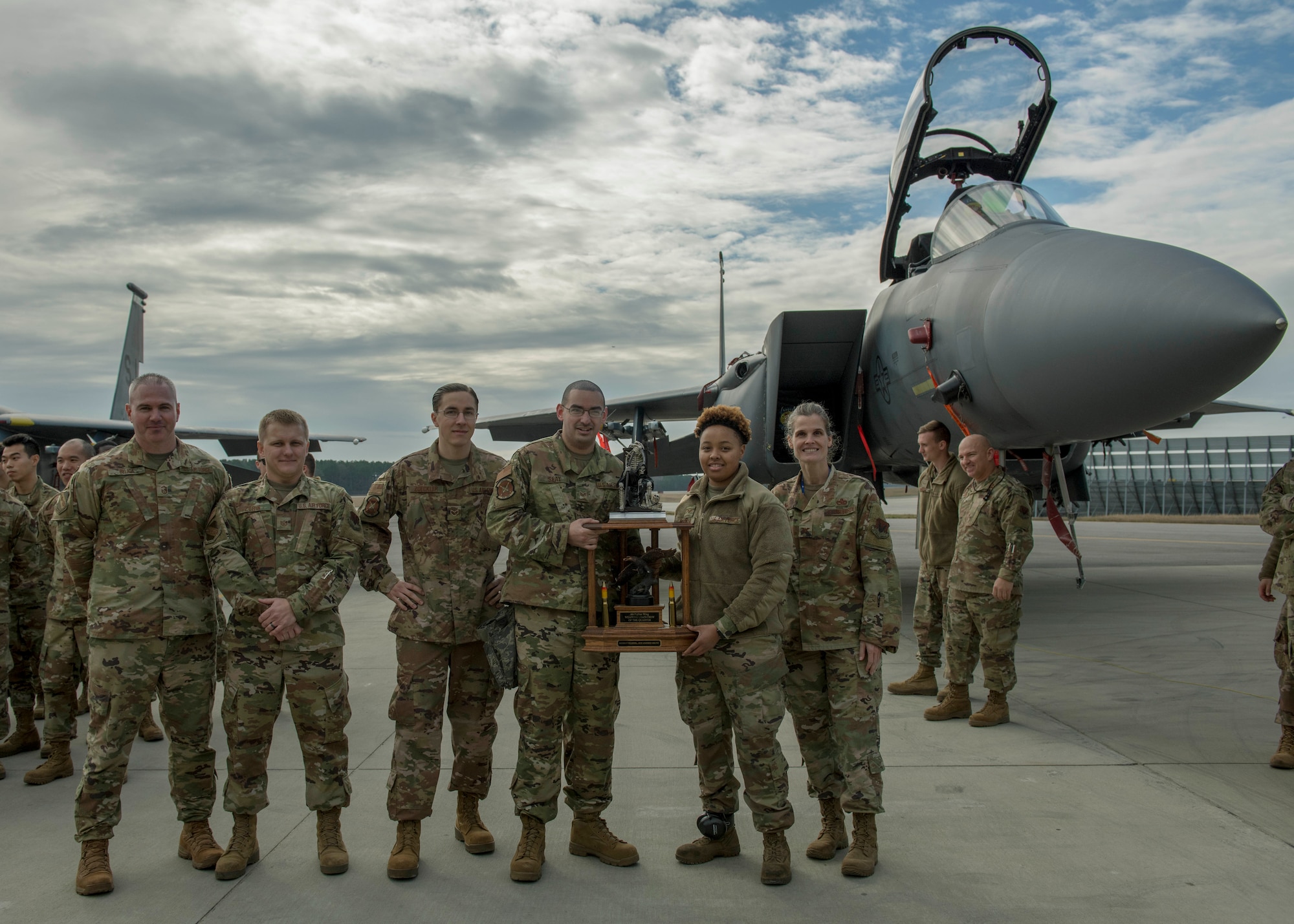 Airmen from the 333rd Aircraft Maintenance Unit receive a trophy after winning a quarterly Load Crew Competition.