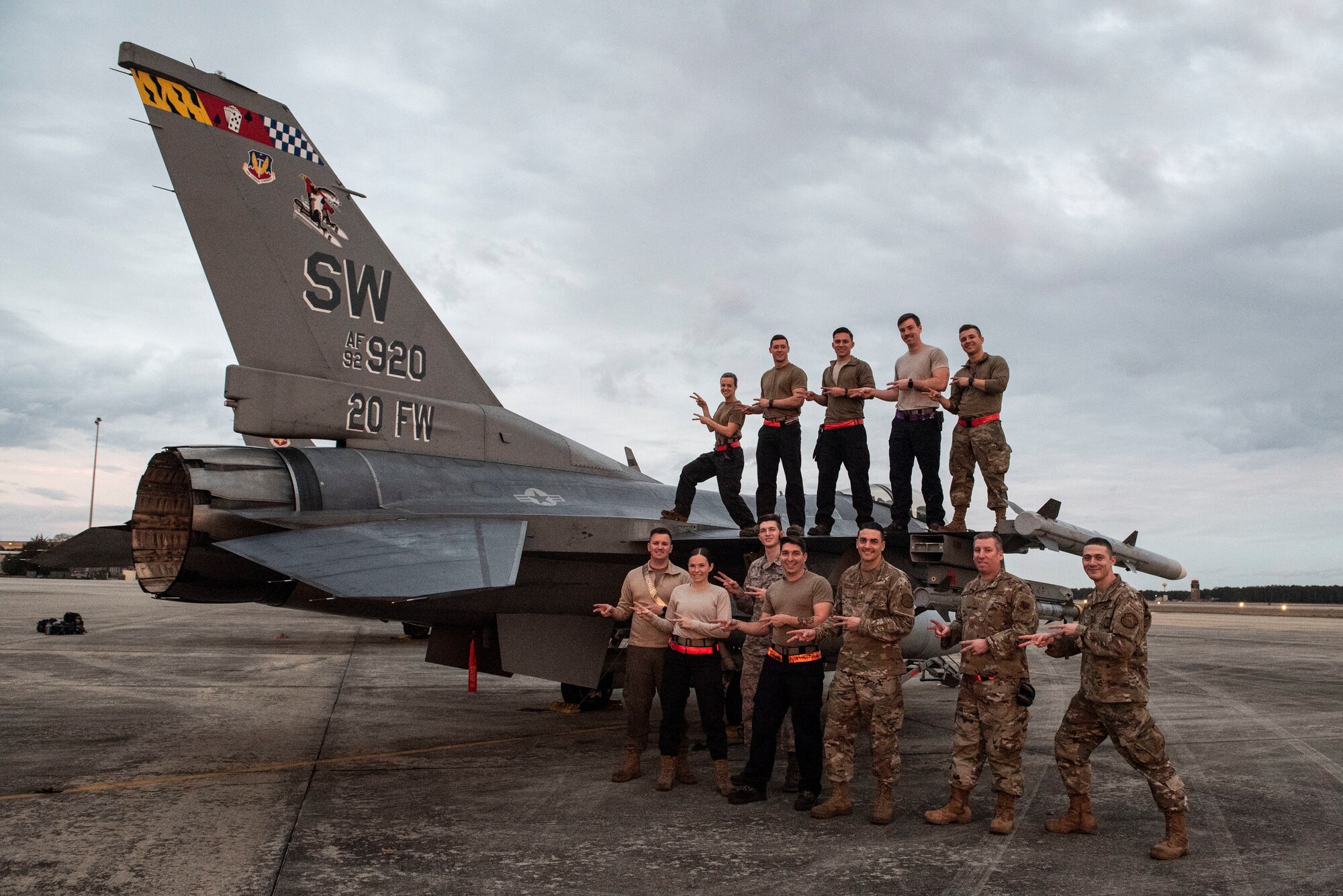 A photo of maintainers posing with their unit signature hand gesture.