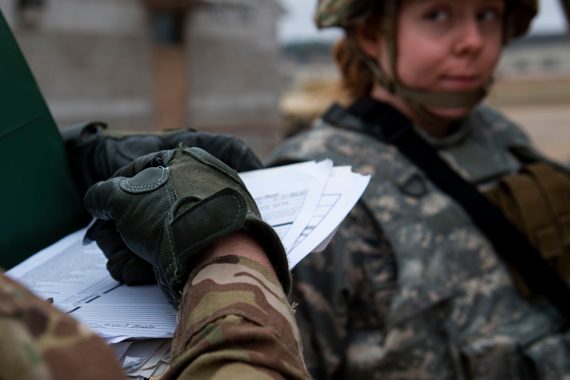 A photo of an Airman completing a checklist during a certification field exercise.
