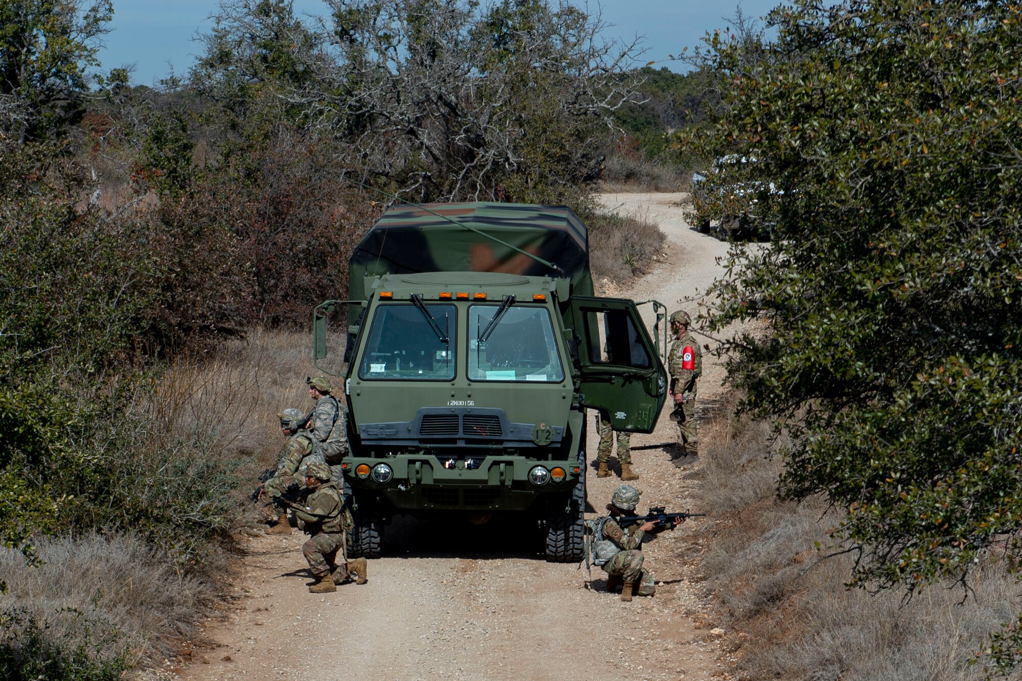 Photo of Airmen assigned to the 3d Weather Squadron perform security around Light Medium Tactical Vehicle during a certification field exercise.
