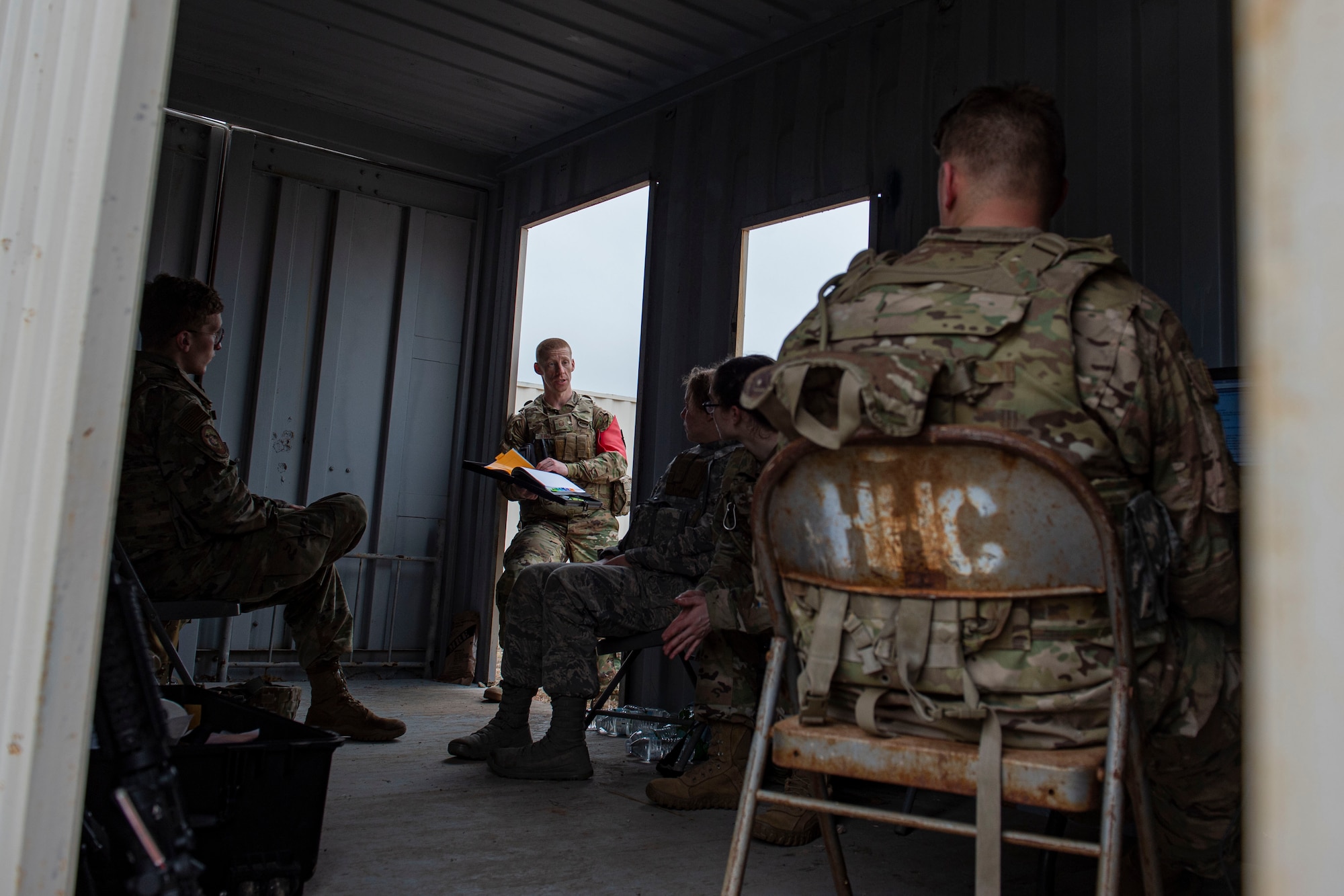 Photo of Airmen assigned to the 3d Weather Squadron debrief after a certification field exercise.