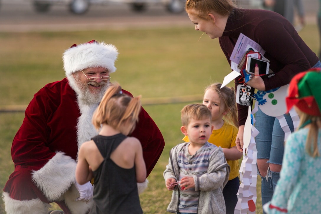 U.S. Marines, Sailors, and their families partake in holiday festivities during the Happy Holidays from Yuma event on the Marine Corps Air Station (MCAS) Yuma Parade Field, Dec. 12, 2019. The event was hosted by MCCS and provided participants with the opportunity to get photos with Santa, eat food, and enjoy holiday music. (U.S. Marine Corps photo by Lance Cpl John Hall)