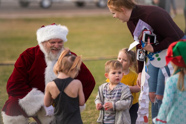 U.S. Marines, Sailors, and their families partake in holiday festivities during the Happy Holidays from Yuma event on the Marine Corps Air Station (MCAS) Yuma Parade Field, Dec. 12, 2019. The event was hosted by MCCS and provided participants with the opportunity to get photos with Santa, eat food, and enjoy holiday music. (U.S. Marine Corps photo by Lance Cpl John Hall)