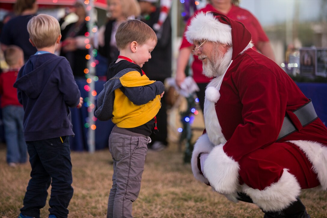 U.S. Marines, Sailors, and their families partake in holiday festivities during the Happy Holidays from Yuma event on the Marine Corps Air Station (MCAS) Yuma Parade Field, Dec. 12, 2019. The event was hosted by MCCS and provided participants with the opportunity to get photos with Santa, eat food, and enjoy holiday music. (U.S. Marine Corps photo by Lance Cpl John Hall)