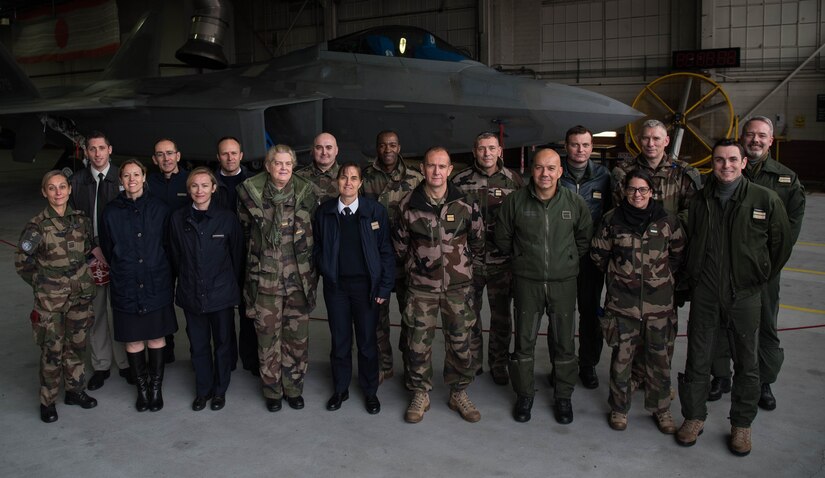 French delegates from the NATO – Allied Command Transformation pose for a photo in front of a U.S. Air Force F-22 Raptor during a visit to Joint Base Langley-Eustis, Virginia, Jan. 24, 2020. During their visit, French delegates learned about the different squadrons that help the 1st Fighter Wing accomplish its mission. (U.S. Air Force photo by Airman 1st Class Marcus M. Bullock)