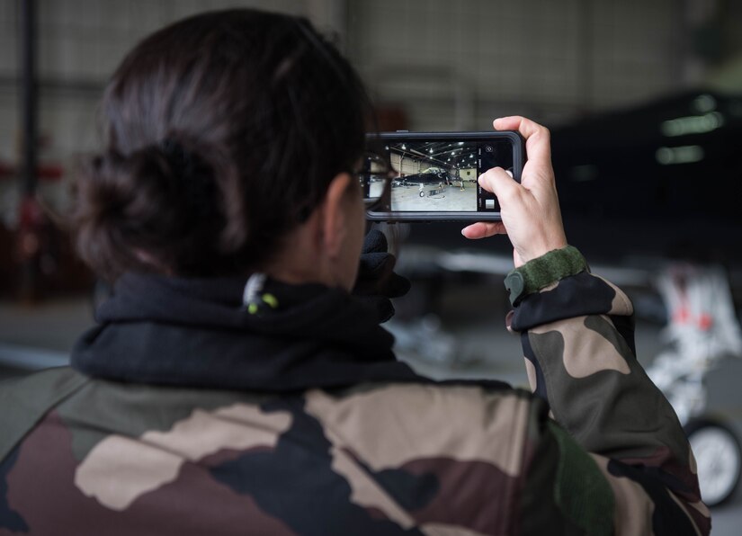 A French delegate snaps a photo of a U.S. Air Force T-38 Talon during a visit to Joint Base Langley-Eustis, Virginia, Jan. 24, 2020. The delegates were able to get up-close and personal with the aircraft and even look into the cockpit of the T-38. (U.S. Air Force photo by Airman 1st Class Marcus M. Bullock)