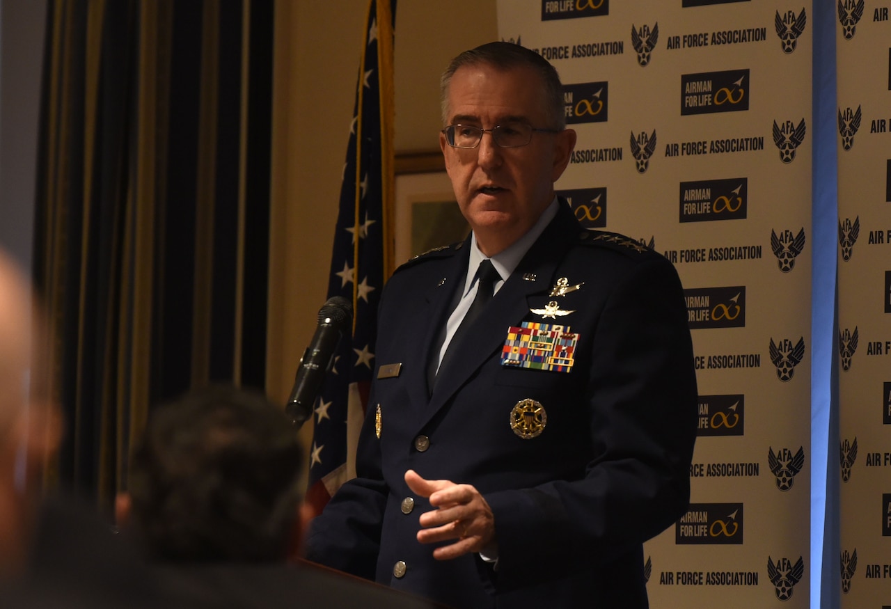 Man in uniform speaks into microphone.