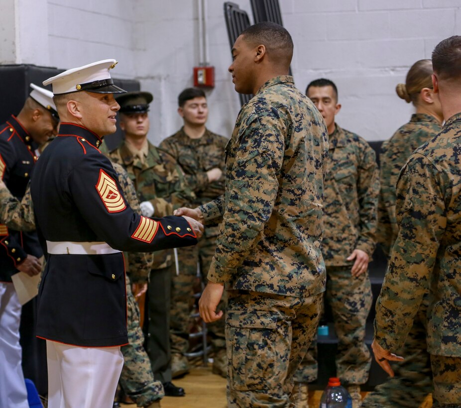 Marines with Marine Barracks Washington D.C. congratulate Master Sgt. Jaxon Luhrs, Marine Corps Community Services, Marine Barracks Washington, at the conclusion of his evaluation during Ceremonial Drill School (CDS) evaluations at Marine Barracks Washington, D.C., Jan. 28, 2020. The three-week CDS course teaches Marines the fundamentals of ceremonial drill that is unique to the “Oldest Post of the Corps.” (U.S. Marine Corps photo by Lance Cpl. Allen Sanders)