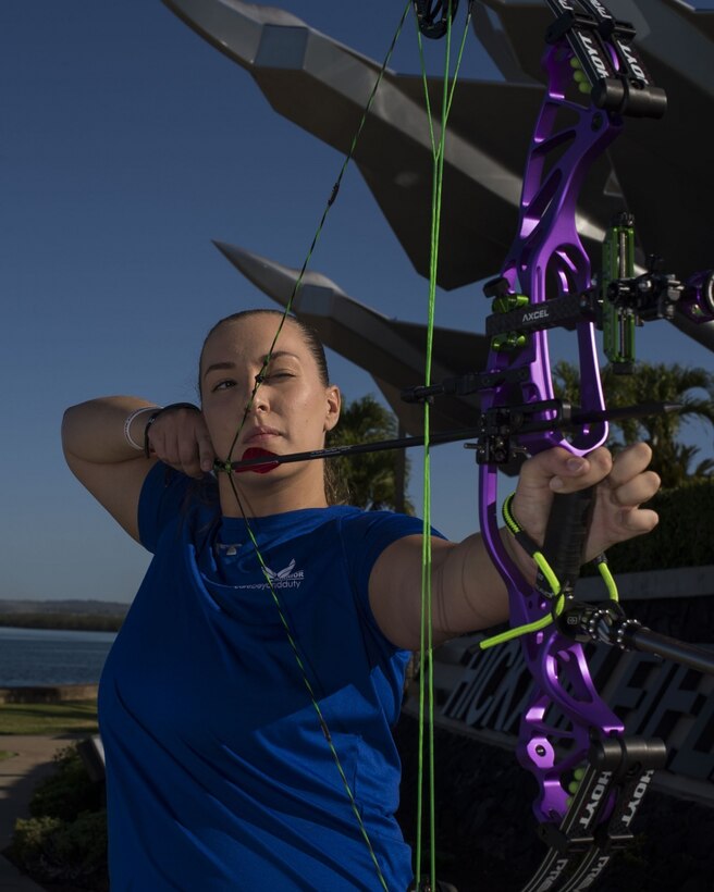 Senior Airman Faith Donato, 647th Security Forces Squadron, poses with her bow and arrow. Donato will serve as an alternate at the 2019 Wounded Warrior Games held this summer in Tampa, Florida. (U.S. Air Force photo by Tech. Sgt. Heather Redman)