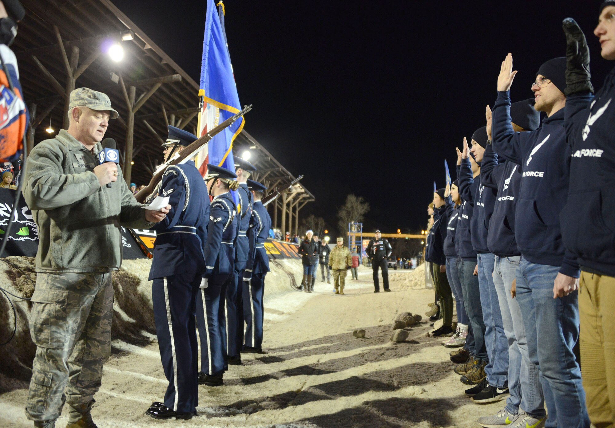 Brig. Gen. Scott Durham, Air Force Recruiting Service, deputy commander, administers the oath of enlistment to 18 new Air Force members during the U.S. Air Force Snocross National in Deadwood, South Dakota.