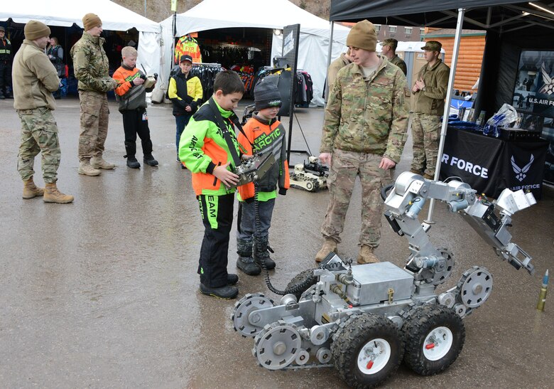 Air Force Total Force recruiters and explosive ordinance device Airmen talk to some young Snocross fans at the U.S. Air Force Snocross National in Deadwood, South Dakota.