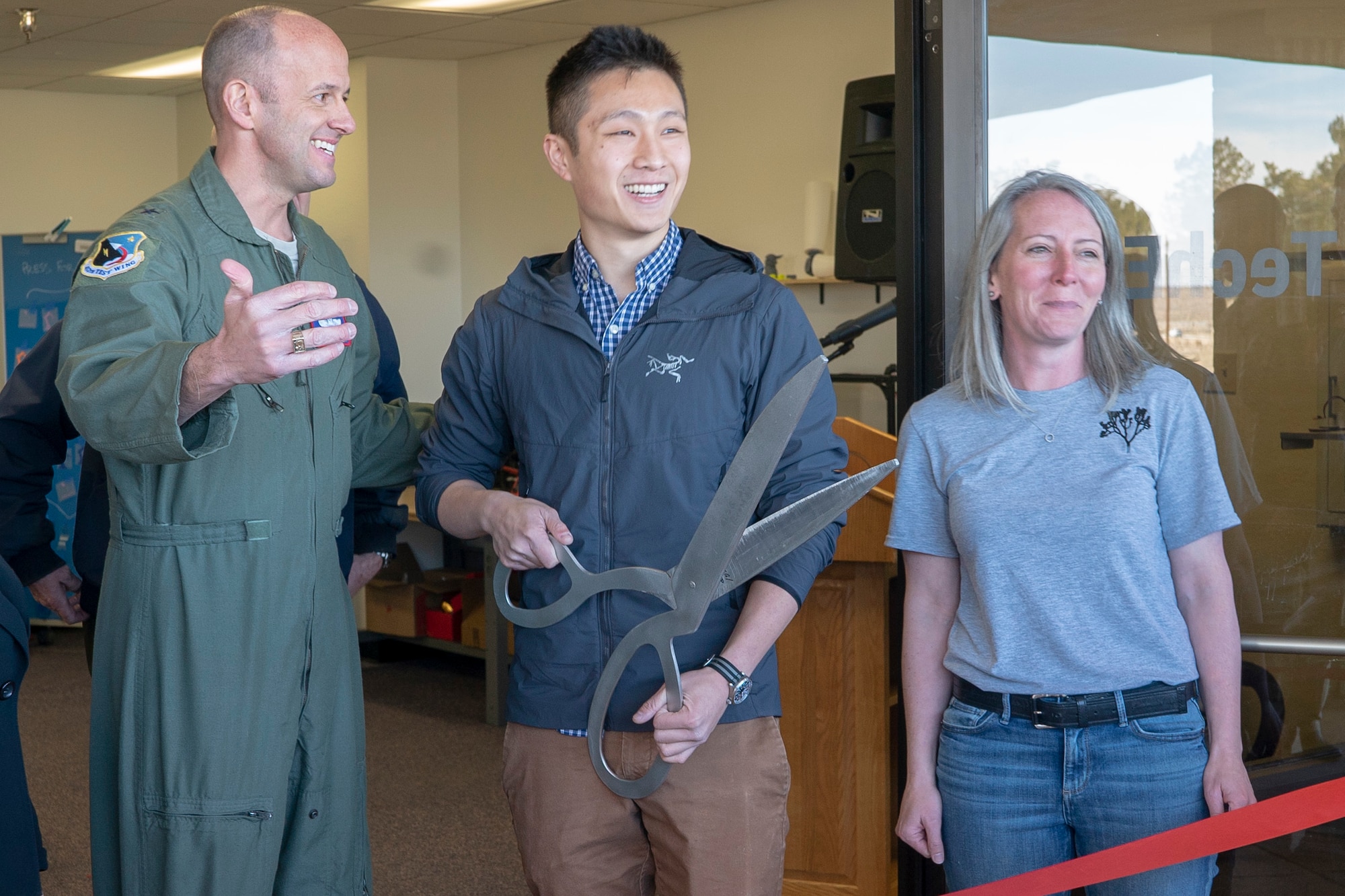 Brig. Gen. E. John Teichert, 412th Test Wing Commander; James M. Wang, program designer and Air Force ROTC student at Stanford University in Palo Alto, Calif.; and Dori Spaulding, command spouse representative for the 412th Operations Group, prepare to launch the TechEd High School Makerspace during a ribbon-cutting ceremony at Edwards Air Force Base, January 29. (Air Force photo by Grady T. Fontana/Released)