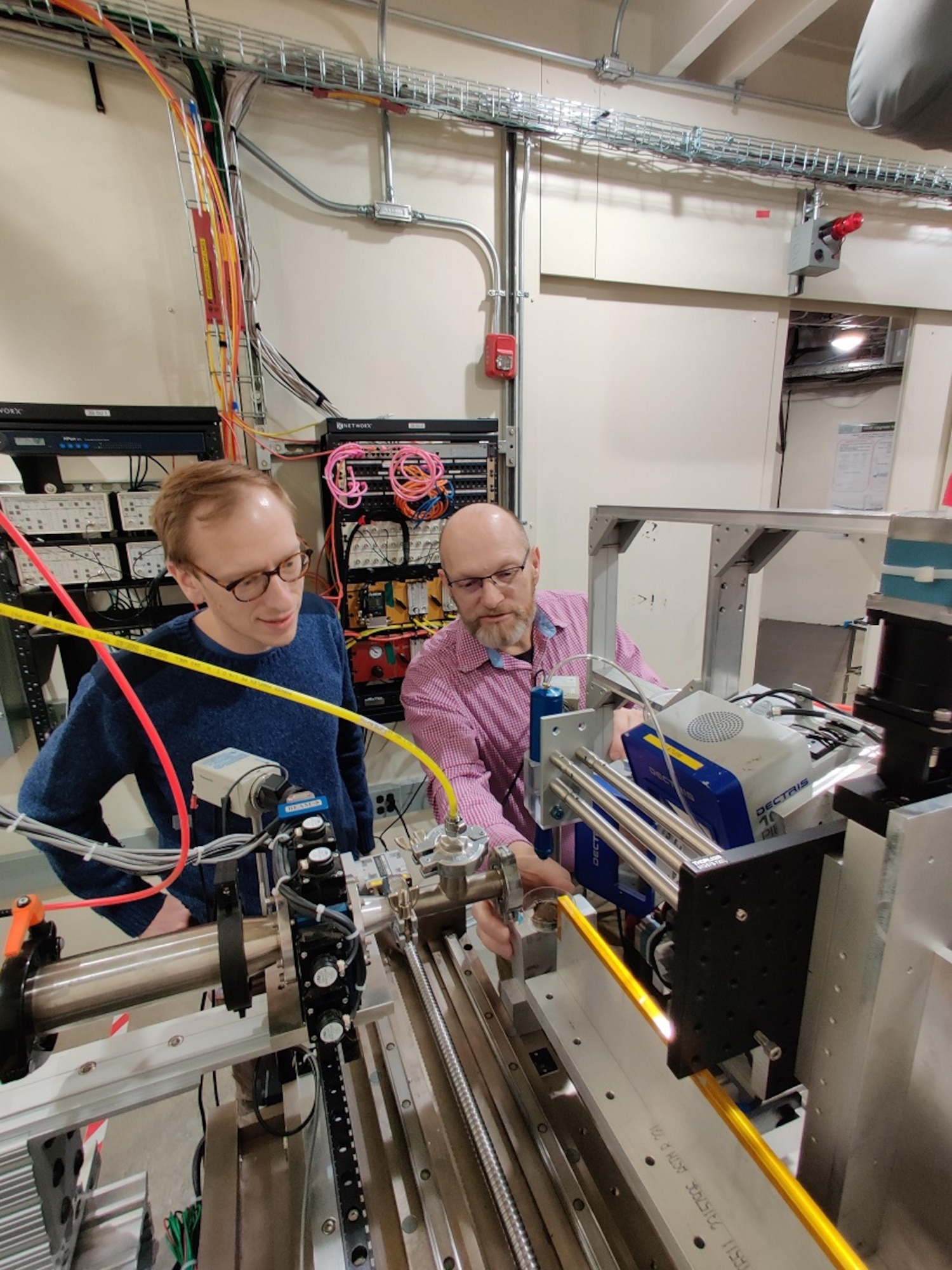 Air Force Research Laboratory personnel Dr. Edward Trigg and Dr. Hilmar Koerner adjust the set-up for additive manufacturing of composites. (Courtesy photo)