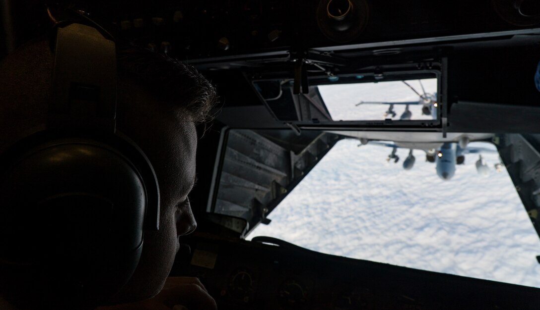 A U.S. Air Force in-flight refueling specialist assigned to the 908th Expeditionary Air Refueling Squadron checks his gauges aboard a KC-10 Extender over the U.S. Central Command area of responsibility.
