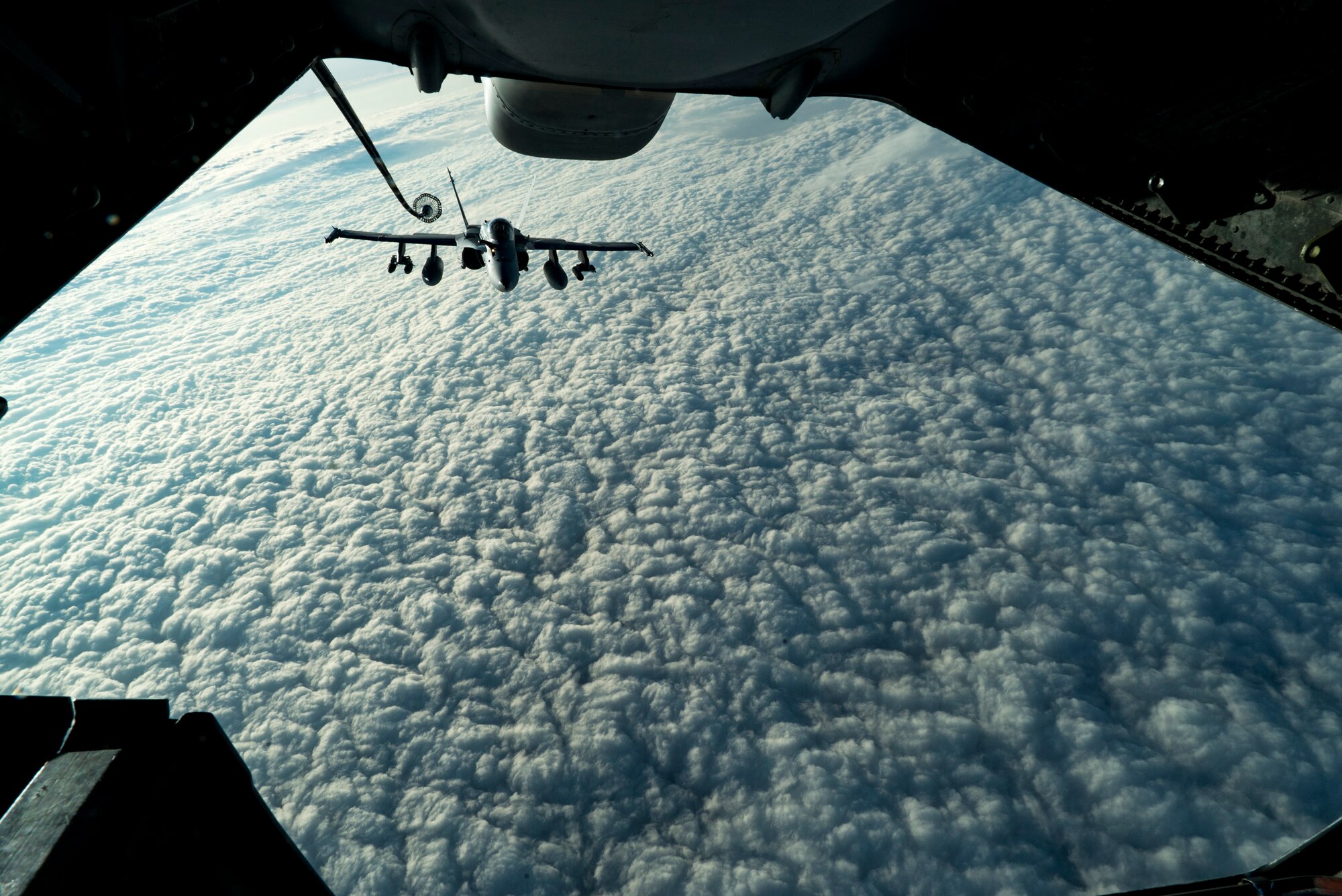 A U.S Marine Corps F/A-18 Hornet assigned to the Marine Fighter Attack Squadron (VMFA) 251 maneuvers toward a KC-10 Extender assigned to the 908th Expeditionary Air Refueling Squadron over the U.S. Central Command area of responsibility, Jan. 22, 2020.