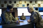 Chief Master Sgt. Jerome Torres, airfield manager of Alpena Combat Readiness Training Center (CRTC), Alpena, Mich., reviews airfield status with Latvian Lt. Liba Mikova, from Lielvārde Air Base, Latvia, as part of the Emerald Warrior 20 exercise at the CRTC Jan. 23, 2020. The two nations have been linked since 1993 under the State Partnership Program.