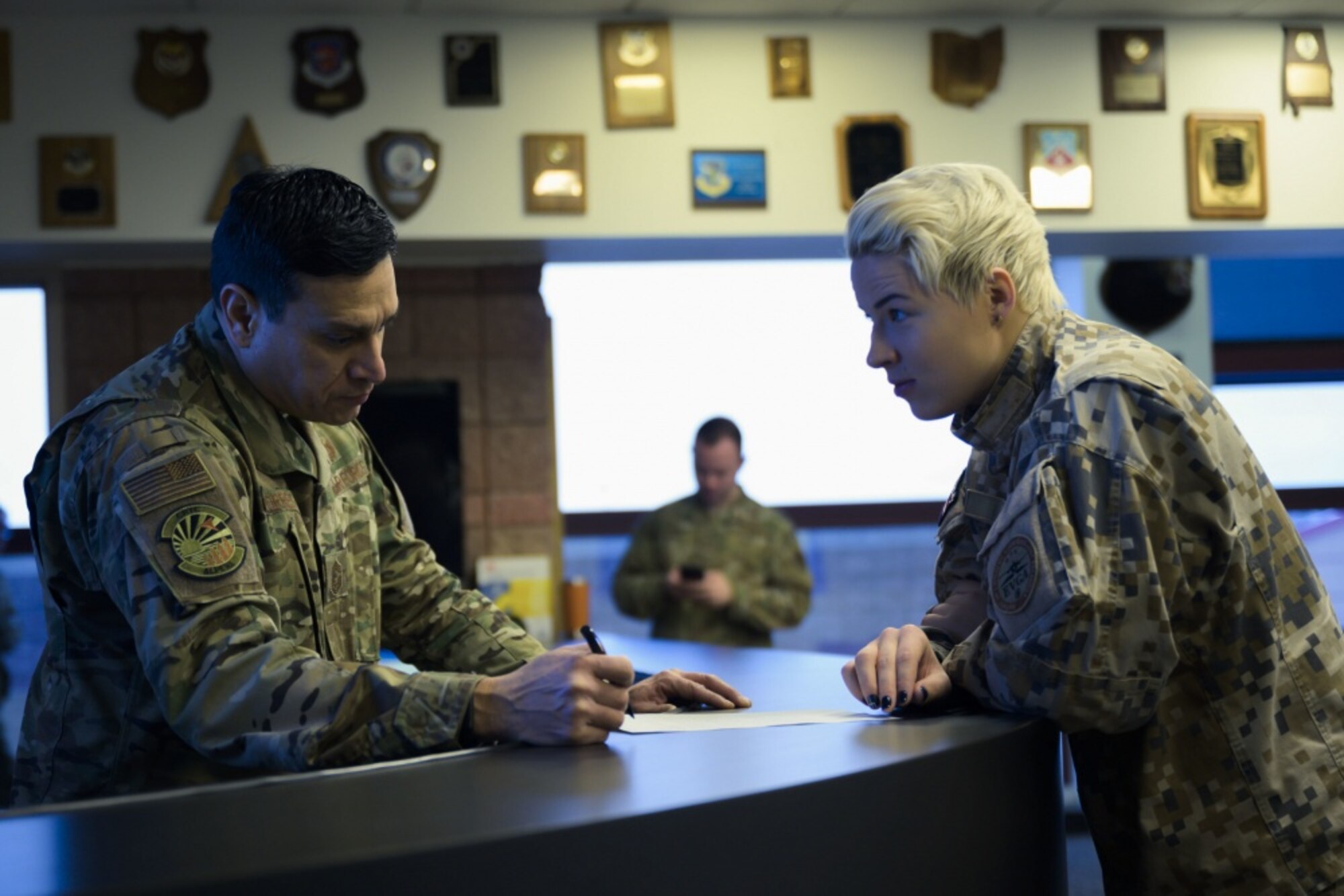U.S. Air Force Chief Master Sgt. Jerome Torres, airfield manager of Alpena Combat Readiness Training Center (CRTC), Alpena, Mich., reviews airfield status with Latvian Lt. Liba Mikova, from Lielvārde Air Base, Latvia, as part of the Emerald Warrior 20 exercise at the CRTC Jan. 23, 2020. The two nations have been linked since 1993 under the State Partnership Program. (U.S. Air National Guard photo by Staff Sgt. Jacob Cessna)