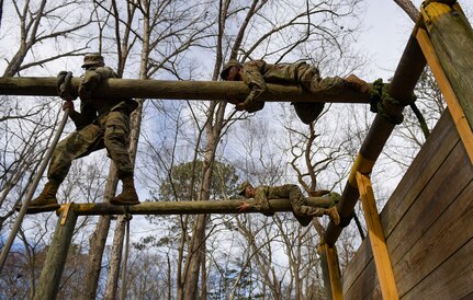 U.S. Army Advanced Individual Training Soldiers maneuver through an obstacle course during a field training exercise at Joint Base Langley-Eustis, Virginia, Jan. 24, 2020.