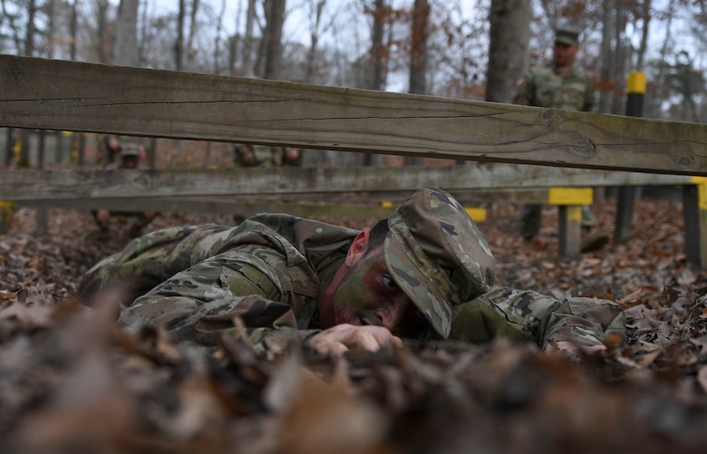 A U.S. Army Advanced Individual Training Soldier crawls under wood planks during a field training exercise at Joint Base Langley-Eustis, Virginia, Jan. 24, 2020.