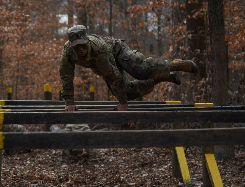 A U.S. Army Advanced Individual Training Soldier jumps over a hurdle during a field training exercise at Joint Base Langley-Eustis, Virginia, Jan. 24, 2020.