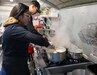 Nayely Vasquez-Sauceda and Sgt. Joshua Vasquez-Sauceda, wheeled vehicle mechanic, 1st Theater Sustainment Command, prepare food while working in their food truck, Papi’s Tacos & More, in Radcliff, Ky., on Jan. 23, 2020. Vasquez-Sauceda is currently on terminal leave and will complete his enlistment in the Army on Feb. 19, 2020