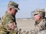 U.S. Air Force Brig. Gen. John C. Walker, left, 378th Air Expeditionary Wing commander, greets U.S. Marine Corps Gen. Kenneth F. McKenzie Jr., right, commander, United States Central Command, at Prince Sultan Air Base, Kingdom of Saudi Arabia, Jan. 29, 2020. The CENTCOM command team’s tour of installations in the command’s area of responsibility underscores the U.S.’s commitment to regional security, the flexibility of American military power, and the importance of military-to-military relationships with coalition partners. (U.S. Air Force photo by Senior Airman Giovanni Sims)