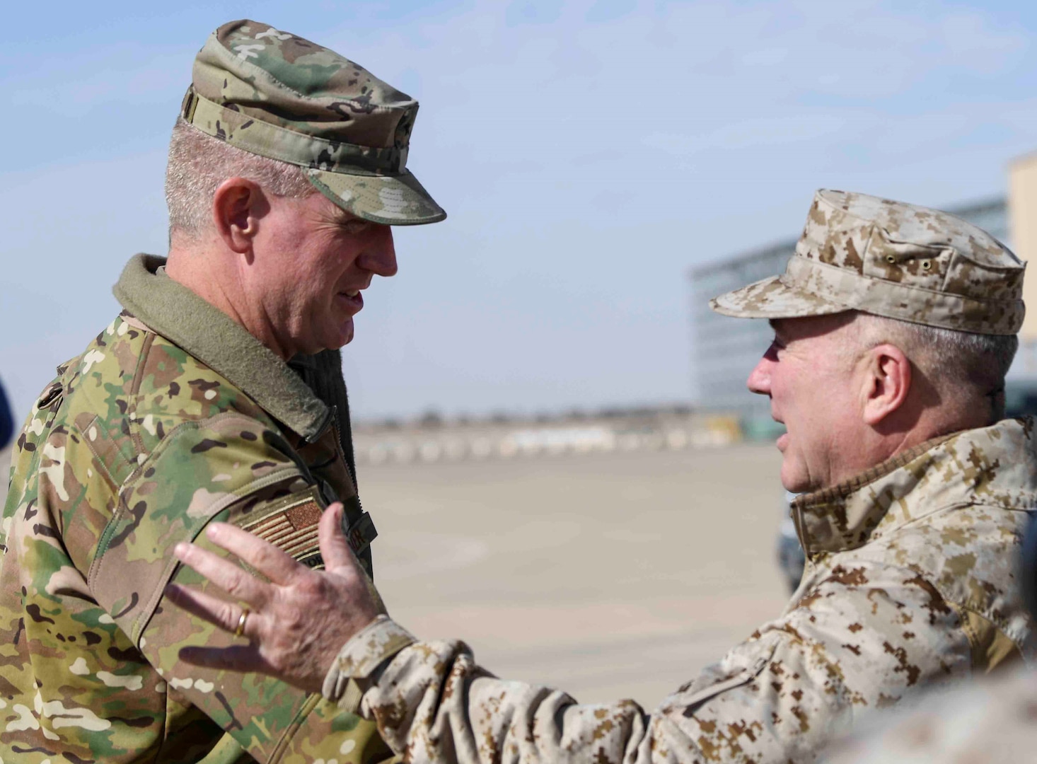 U.S. Air Force Brig. Gen. John C. Walker, left, 378th Air Expeditionary Wing commander, greets U.S. Marine Corps Gen. Kenneth F. McKenzie Jr., right, commander, United States Central Command, at Prince Sultan Air Base, Kingdom of Saudi Arabia, Jan. 29, 2020. The CENTCOM command team’s tour of installations in the command’s area of responsibility underscores the U.S.’s commitment to regional security, the flexibility of American military power, and the importance of military-to-military relationships with coalition partners. (U.S. Air Force photo by Senior Airman Giovanni Sims)