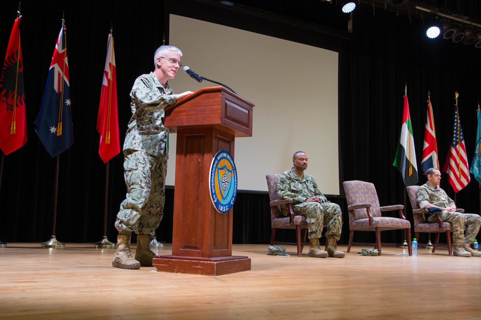 Vice Adm. Jim Malloy, commander of U.S. Naval Forces Central Command, U.S. 5th Fleet and Combined Maritime Forces, delivers remarks as a guest speaker during a change of command ceremony for the International Maritime Security Construct (IMSC). Rear Adm. Alvin Holsey, commander of IMSC, was relieved by Royal Navy Commodore James Parkin during the ceremony. IMSC maintains the freedom of navigation, international law, and free flow of commerce to support regional stability and security of the maritime commons.