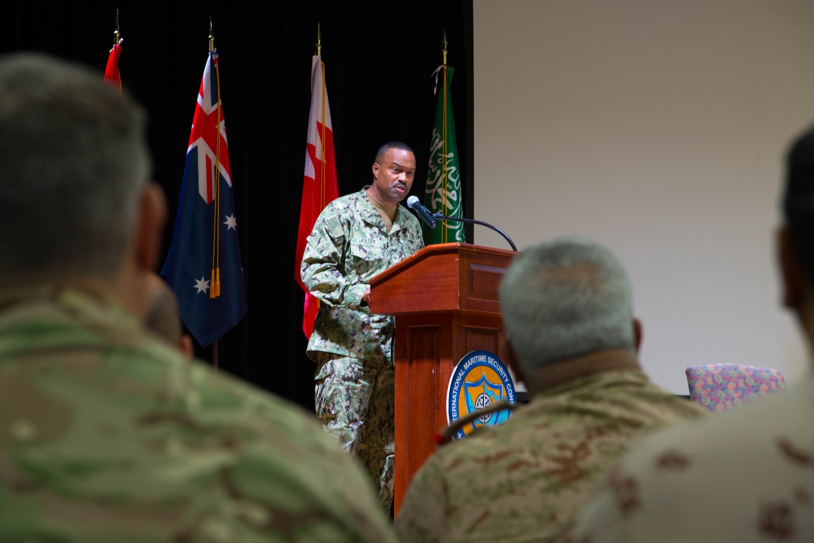 Rear Adm. Alvin Holsey, commander of the International Maritime Security Construct (IMSC), delivers remarks during a change of command ceremony for the IMSC. Holsey was relieved by Royal Navy Commodore James Parkin during the ceremony. IMSC maintains the freedom of navigation, international law, and free flow of commerce to support regional stability and security of the maritime commons.
