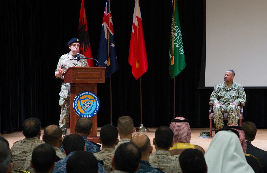 Royal Navy Commodore James Parkin delivers remarks after assuming command of the International Maritime Security Construct (IMSC) during a change of command ceremony. Parkin relieved Rear Adm. Alvin Holsey during the ceremony. IMSC maintains the freedom of navigation, international law, and free flow of commerce to support regional stability and security of the maritime commons.