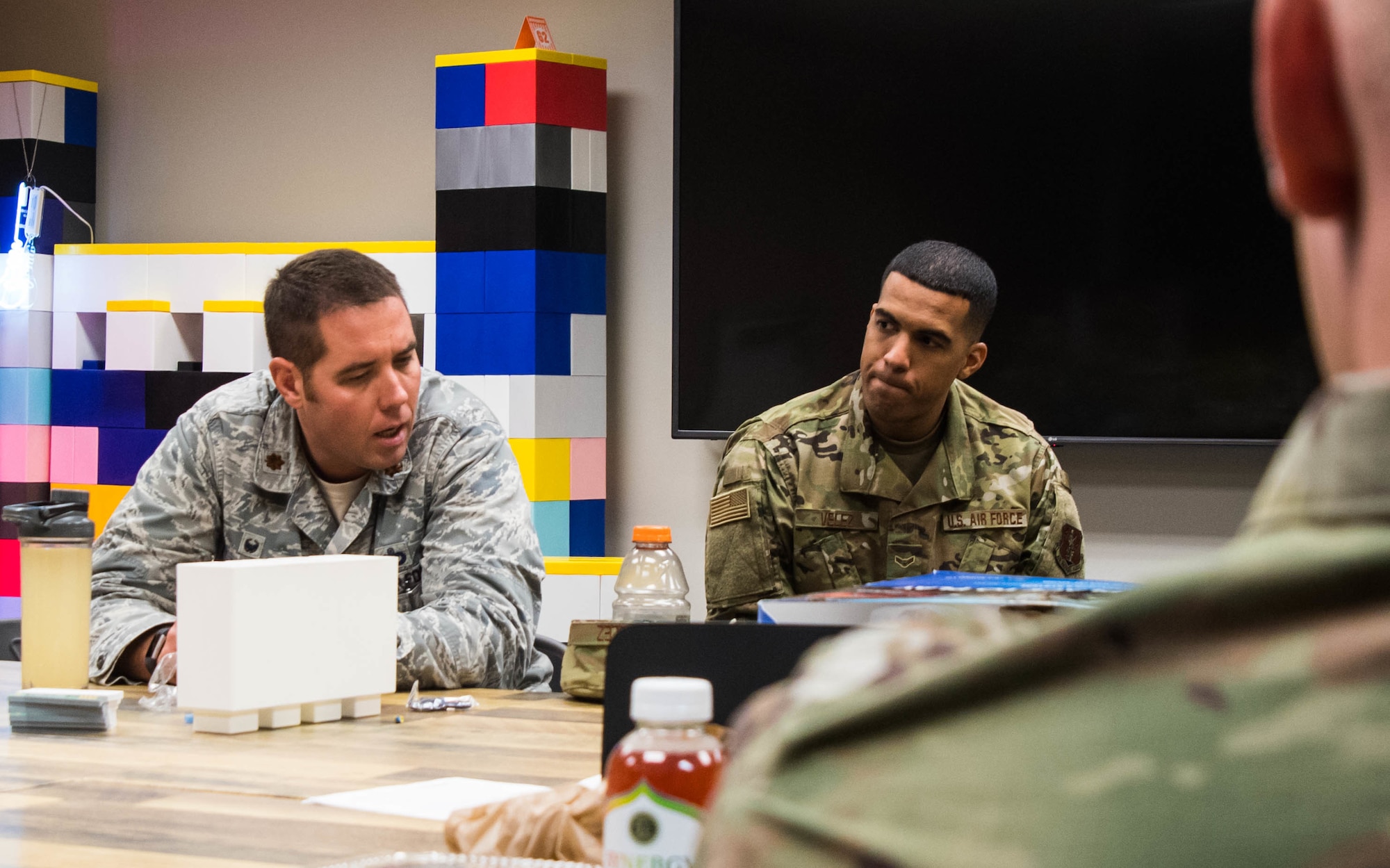 Two Texas Air National Guard members discuss innovative ideas and ongoing projects in the Innovation Room.