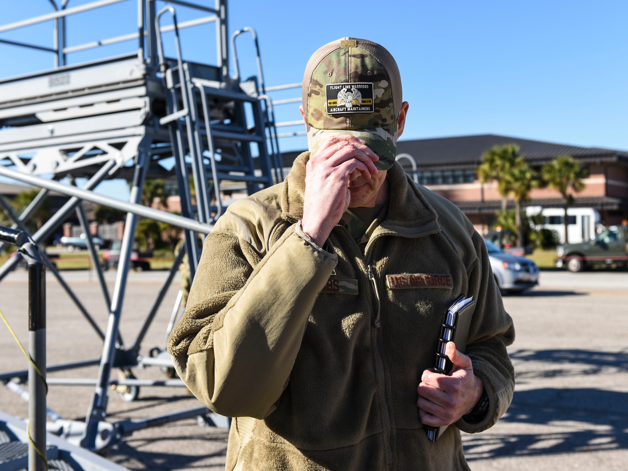 Brig. Gen. Richard W. Gibbs, Air Mobility Command Logistics, Engineering and Force Protection director, dons a cap featuring a flight line warriors aircraft maintainers patch at Joint Base Charleston, S.C., Jan. 28, 2020.