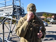 Brig. Gen. Richard W. Gibbs, Air Mobility Command Logistics, Engineering and Force Protection director, dons a cap featuring a flight line warriors aircraft maintainers patch at Joint Base Charleston, S.C., Jan. 28, 2020.