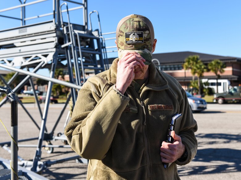 Brig. Gen. Richard W. Gibbs, Air Mobility Command Logistics, Engineering and Force Protection director, dons a cap featuring a flight line warriors aircraft maintainers patch at Joint Base Charleston, S.C., Jan. 28, 2020.