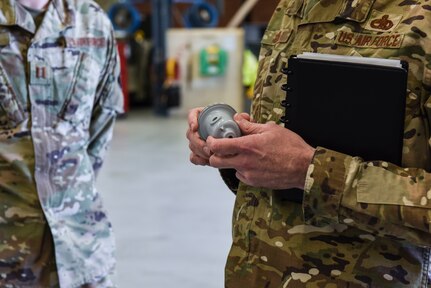 Brig. Gen. Richard W. Gibbs, Air Mobility Command Logistics, Engineering and Force Protection director, examines a 3-D printed fuel truck cap valve at Joint Base Charleston, S.C., Jan. 28, 2020.