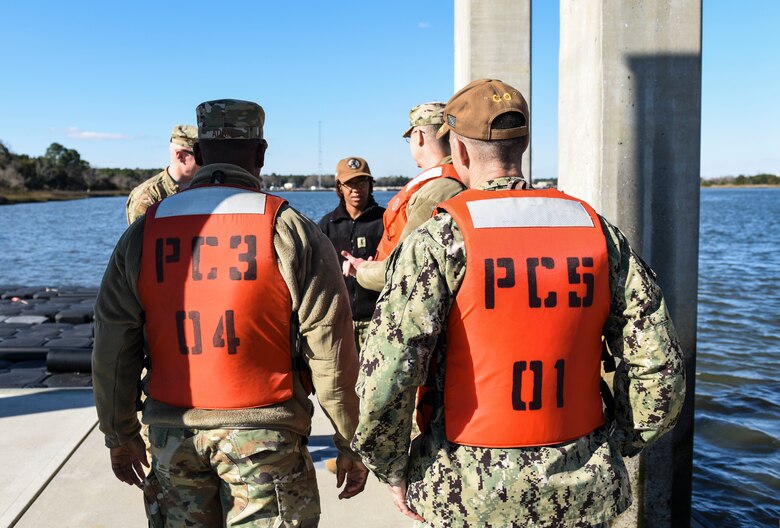 Team Charleston leadership listen to a briefing  after a ride-along in a harbor security patrol boat at Joint Base Charleston, S.C., Jan. 28, 2020.