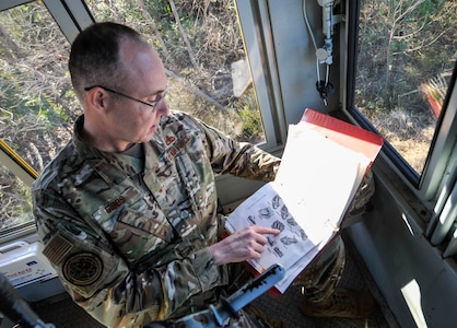 Brig. Gen. Richard W. Gibbs, Air Mobility Command Logistics, Engineering and Force Protection director, examines a locomotive handbook at Joint Base Charleston, S.C., Jan. 28, 2020.