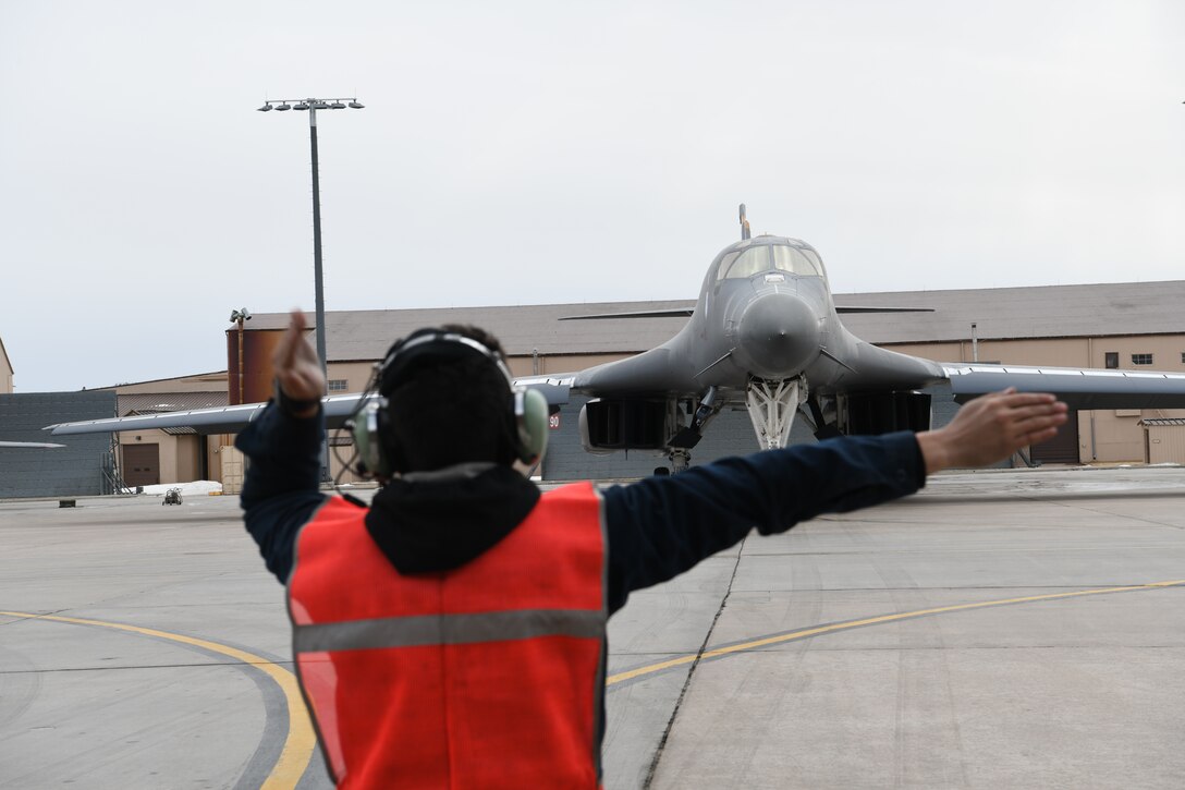 Airman Jacob Martinez, a 37th Bomb Squadron crew chief, ushers a B-1B Lancer at Ellsworth Air Force Base, S.D., Jan. 22, 2020. Red Flag is the U.S. Air Force's premier air-to-air combat training exercise. (U.S. Air Force photo by Senior Airman Nicolas Z. Erwin)