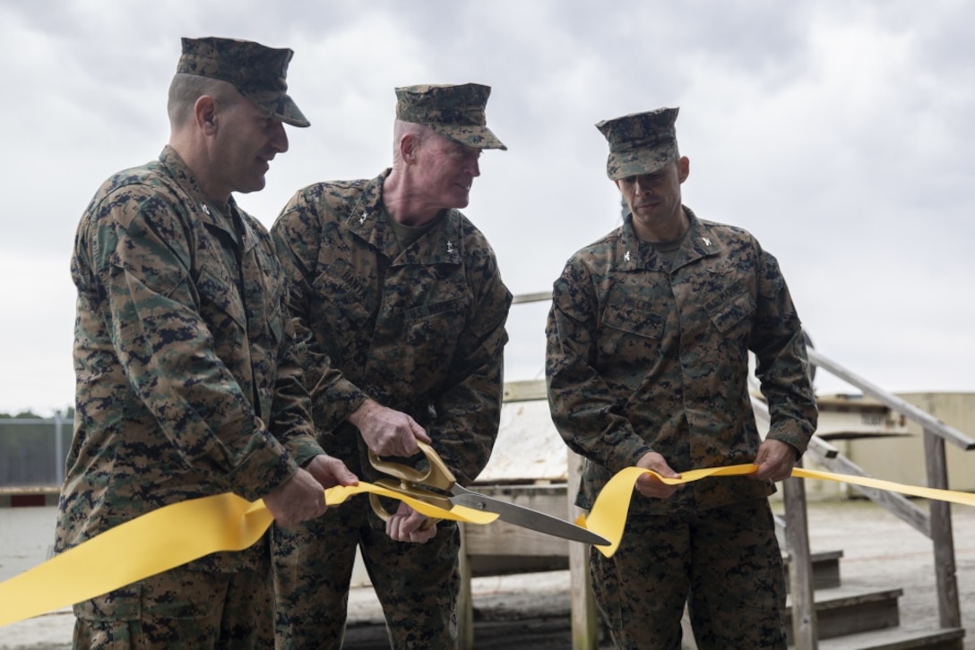 (Left) Col. Frank N. Latt, 2nd Marine Aircraft Wing, (middle) Assistant Wing Commander, Maj. Gen. Edward D. Banta, Commander, Marine Corps Installations Command, Assistant Deputy Commandant, and (right) Col. Timothy P. Miller, Commanding Officer, Marine Corps Air Station Beaufort cut the ceremonious ribbon to commemorate the expansion and modernization of Townsend Bombing Range, the East Coast’s premier air-to-ground bombing range. The range has expanded from 5,183 acres to 33,834 acres which now allows pilots and air crews to train with precision guided munitions. TBR will continue to allow our pilots to train to deploy without deploying to train. (U.S. Marine Corps photo by Lance Cpl. Nicholas Buss)